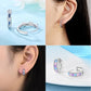 Collage of silver hoop earrings with colorful stones worn by a person.