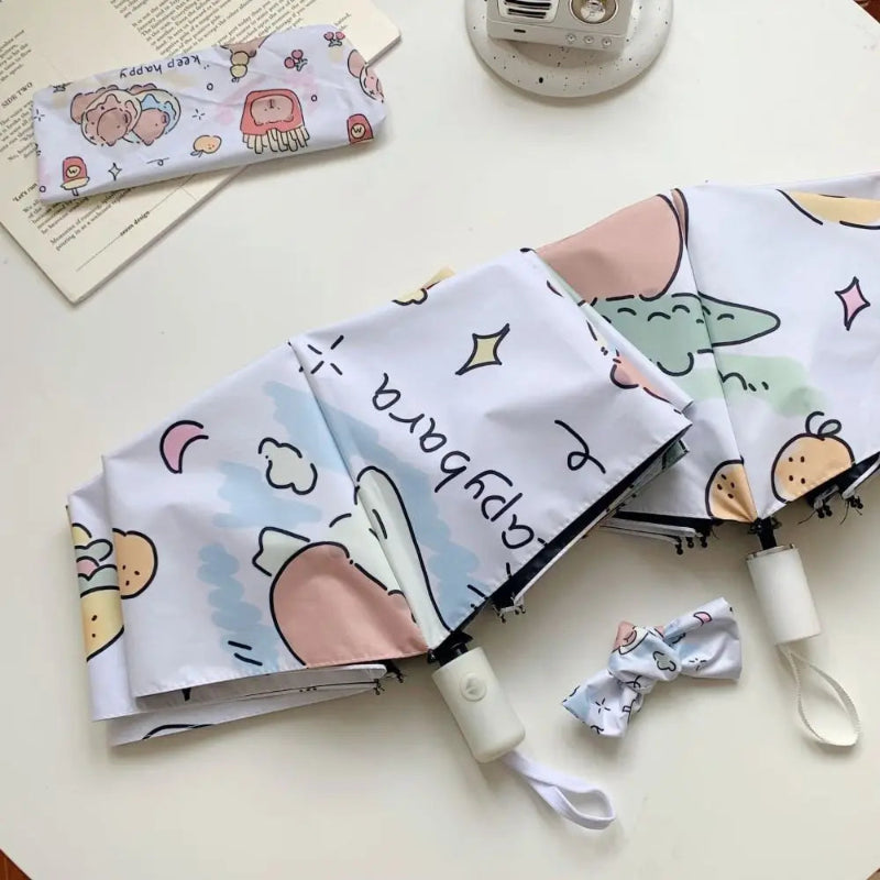 kawaii capybara umbrella on white table surface