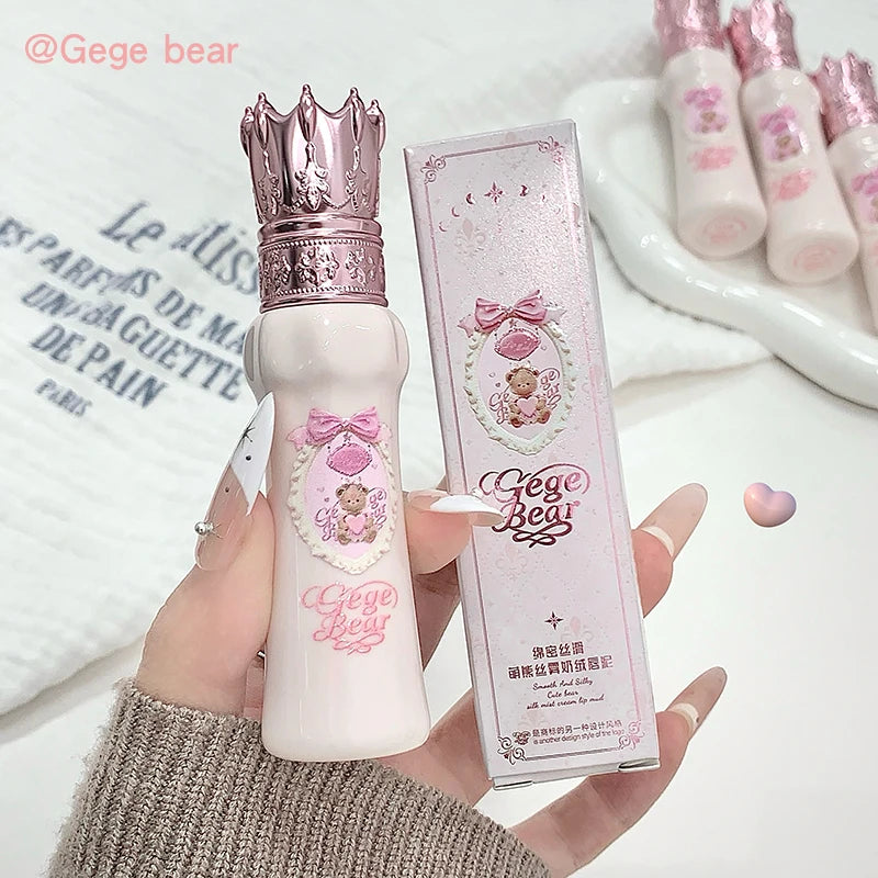 White bottle with pink crown and packaging labeled 'Gege Bear' held by a hand.