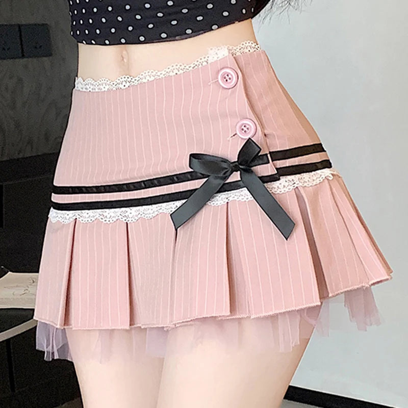 Pink pleated skirt with a black ribbon and buttons on a neutral background