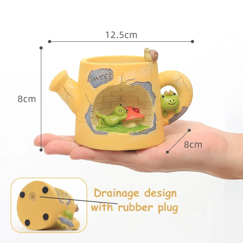 Yellow ceramic teapot with frog design held in a hand, showing measurements and drainage design details.