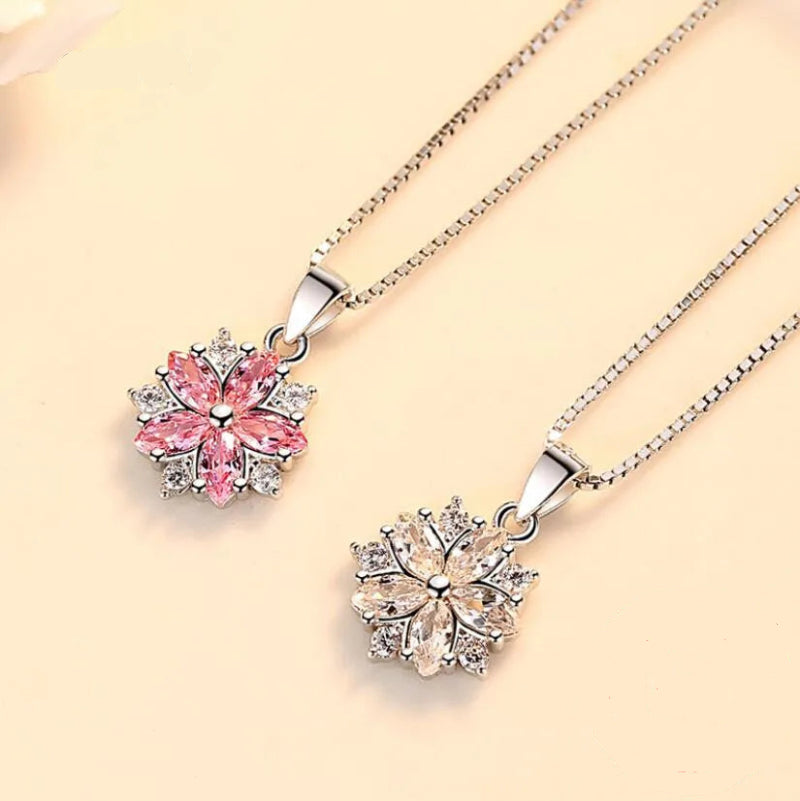 Sakura Cherry Blossom Necklace the hot pink version and the light pink version displayed together side by side on a pink background