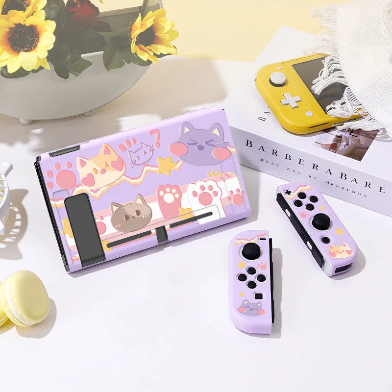Gaming console set with cat-themed design on a light surface.