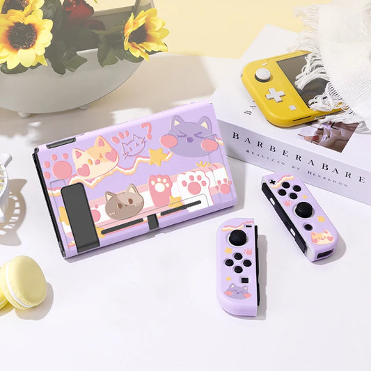 Gaming console set with cat-themed design on a light surface.