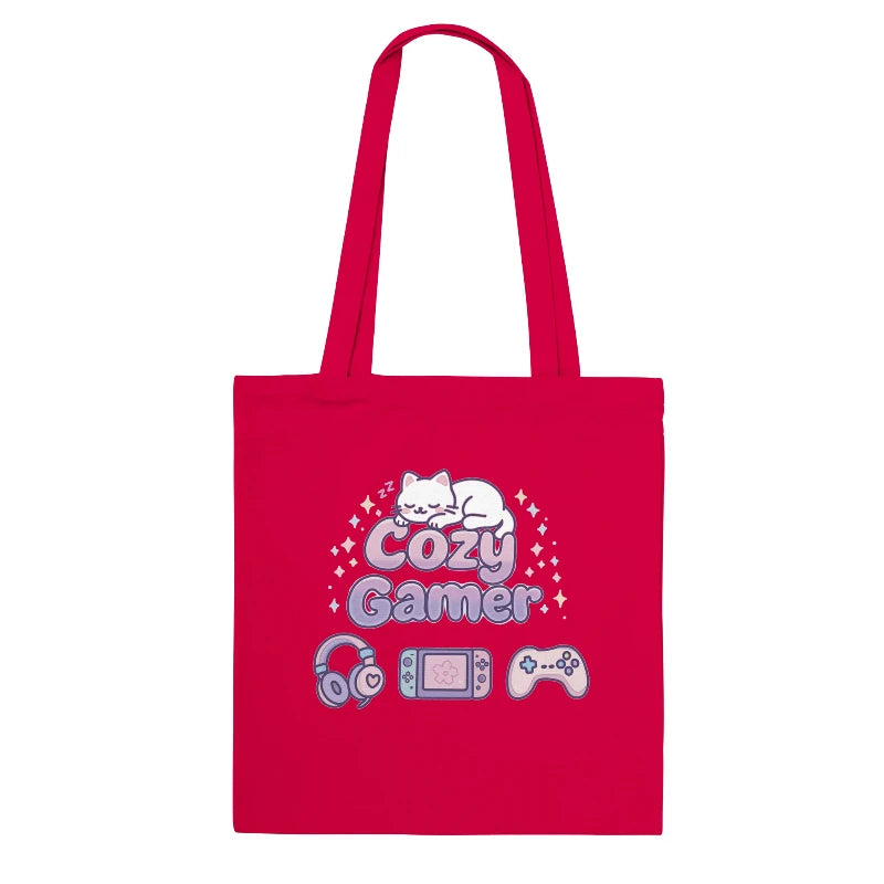 Red tote bag with 'Cozy Gamer' design featuring a cat, gaming console, headphones, and controller on a white background.