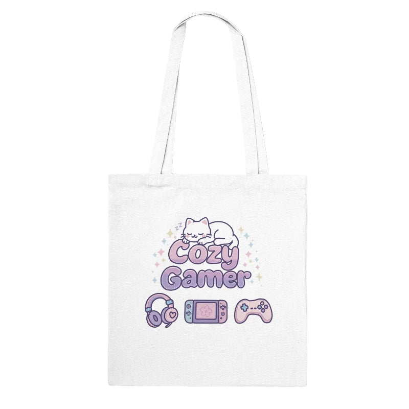 White tote bag with 'Cozy Gamer' design featuring a cat, gaming console, headphones, and controller on a white background.