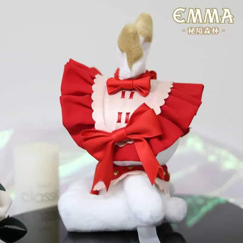 Strawberry Red Emma Plush Keychain, side view of the product on a glass table.
