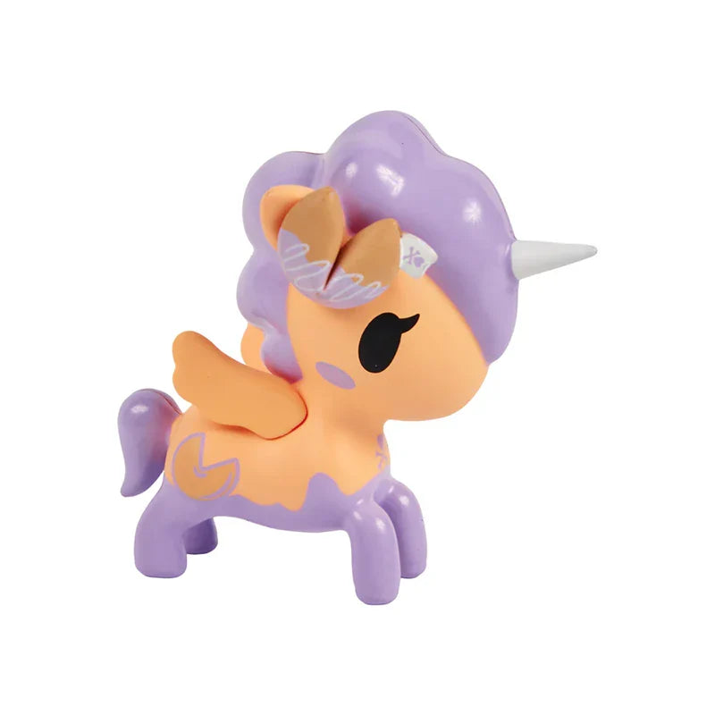 Toy unicorn with purple hair and wings on a white background
