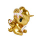 Gold figurine with a white bow and red accents on a white background