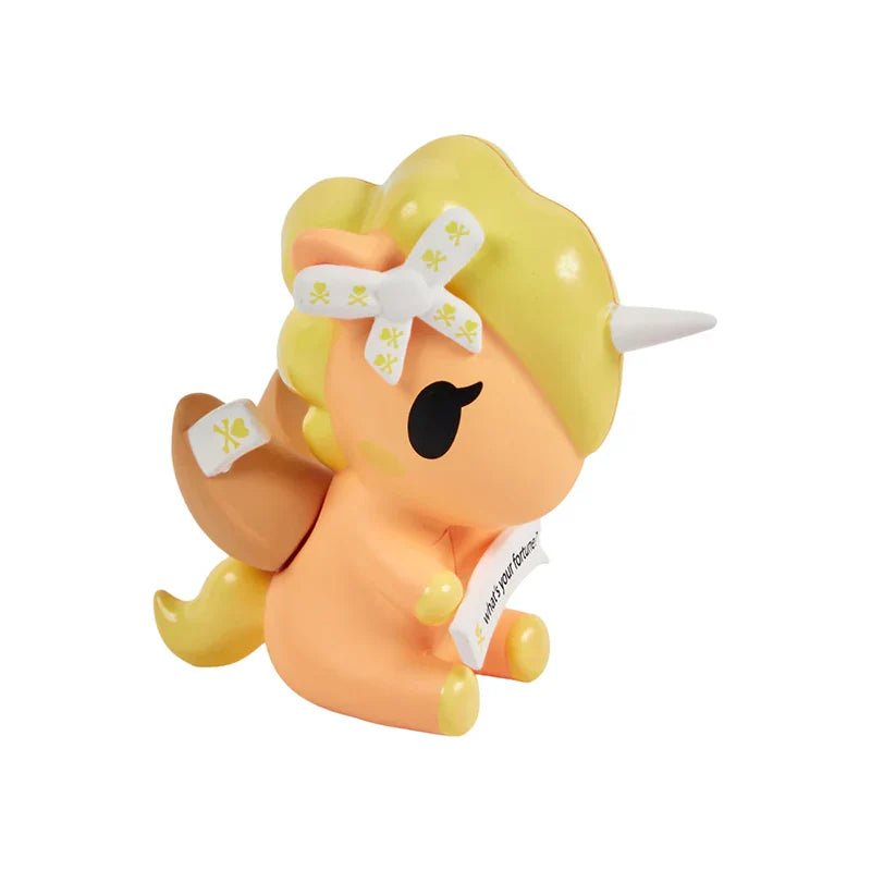 Plush toy with yellow hair, black eye, and white bow on a white background