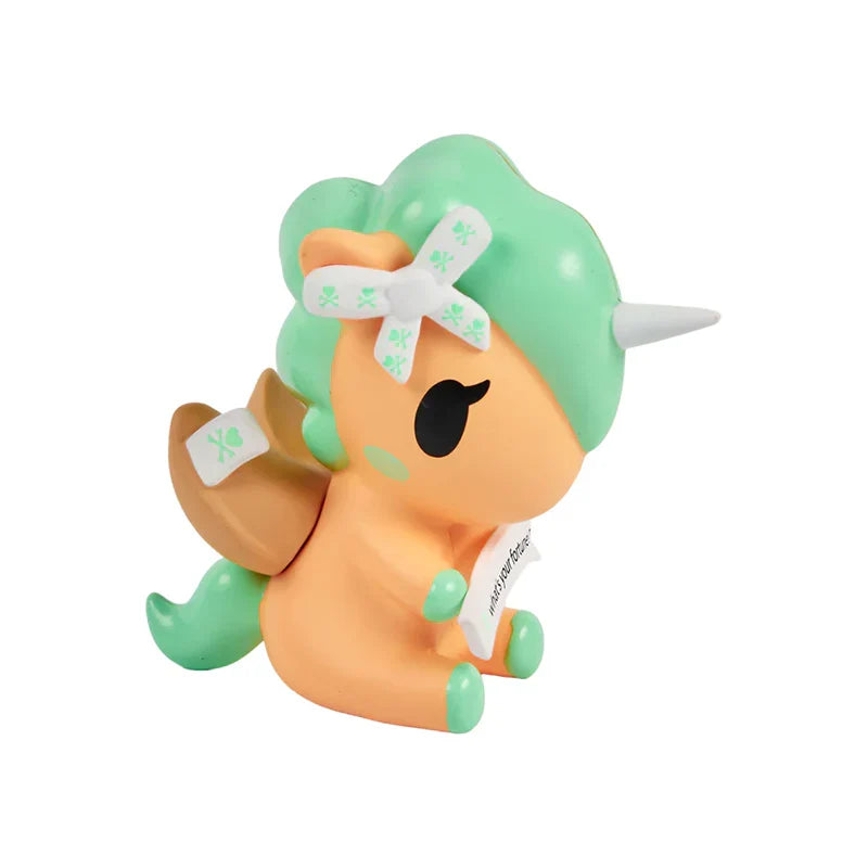 Toy figure with green hair and orange body on a white background