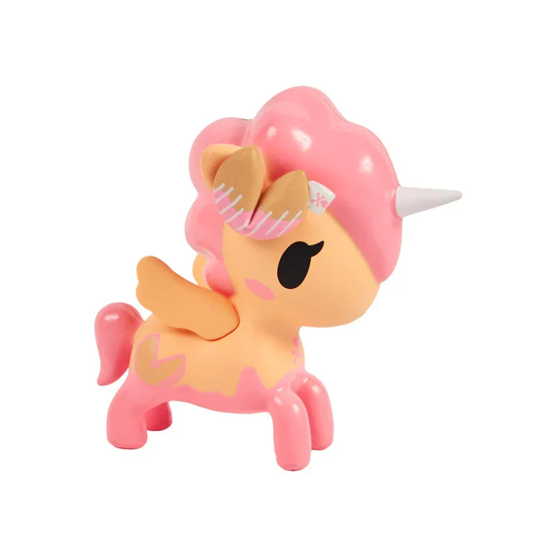 Toy unicorn with pink hair and body on a white background
