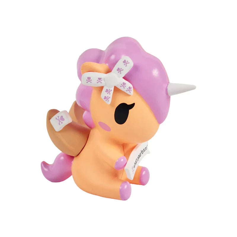 Toy figure with pink hair and orange body on a white background
