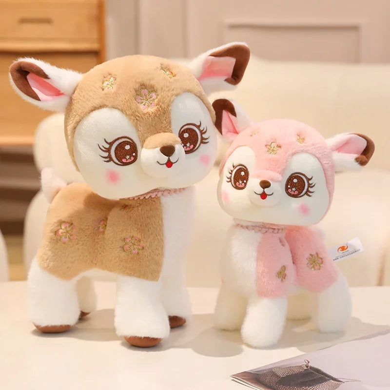 Two plush deer toys, one in beige and the other in pink, on a light surface.