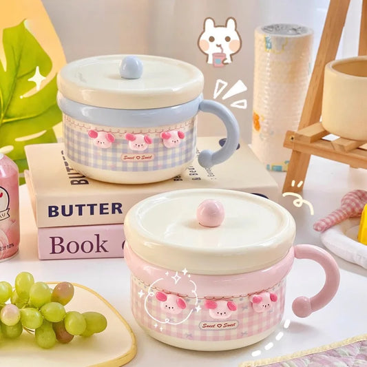 Two kawaii ramen bowls wtith puppy designs on a table with books and grapes.