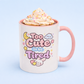 Kawaii Mug with 'Too Cute to be Tired' text and pink handle, filled with a hot beverage and whipped cream.
