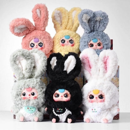 Colorful blind box plush toys with bunny ears on a white background