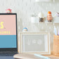 Laptop on a desk with 'mofusand' branding, surrounded by decorative items.
