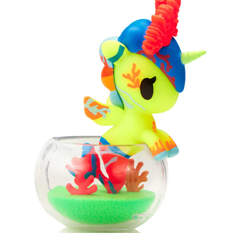 Kawaii unicorn blind box figure with a blue  and red hair in a clear container on a white background