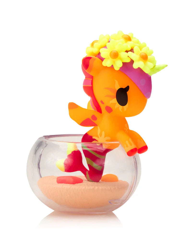 Kawaii blind box unicorn figure with a flower crown in a glass bowl on a white background