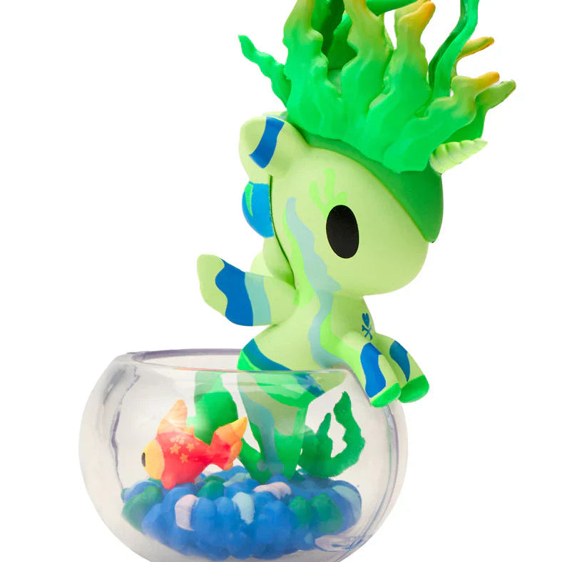 Kawaii blindbox unicorn figure with green hair and blue accents in a clear fishbowl with colorful decorations.