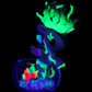 Glow in the dark unicorn figurine with fish and plants in a dark setting