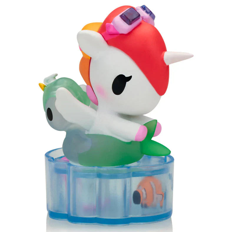 Colorful toy figure of a character with a transparent blue base on a white background