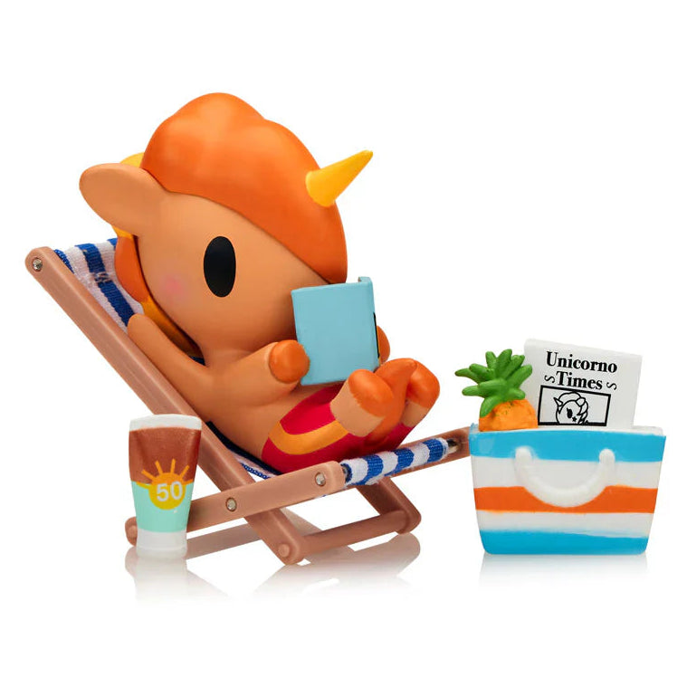 Unicorn-like character reading a book on a beach chair with a cup and towel.