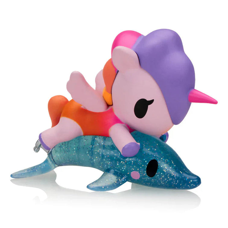 Colorful toy figure of a character riding a blue dolphin on a white background