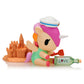 Kawaii blind box toy figure of a unicorn with a sandcastle and bottle on a white background