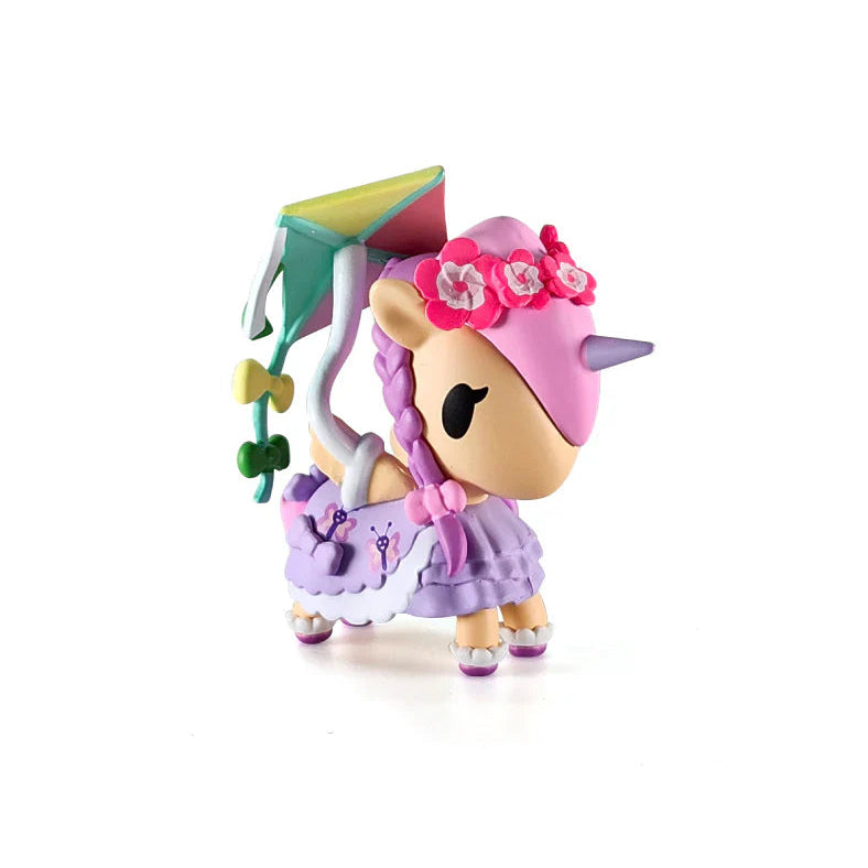 Kawaii Unicorn blind box figure with pink hair and a kite on a white background