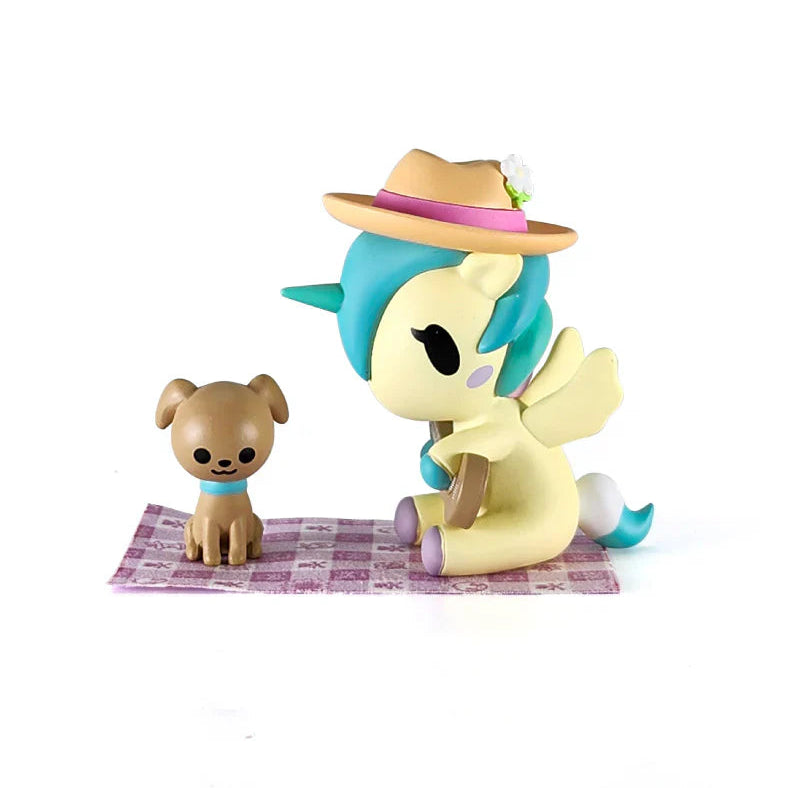 Two figurines on a purple blanket with a white background