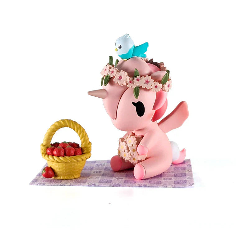 Pink kawaii unicorn figure with a flower crown and basket of apples on a white background