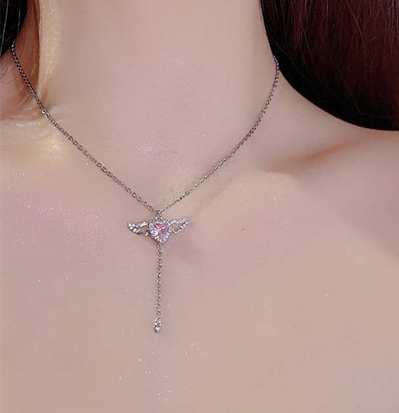 Model Wearing Silver Tone Pink Crystal Heart Angel Wings Pendant Necklace