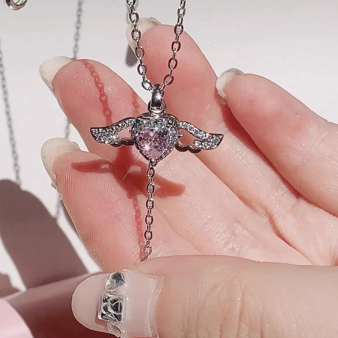 Hand Holding Kawaii Pink Crystal Heart Angel Wings Pendant Necklace