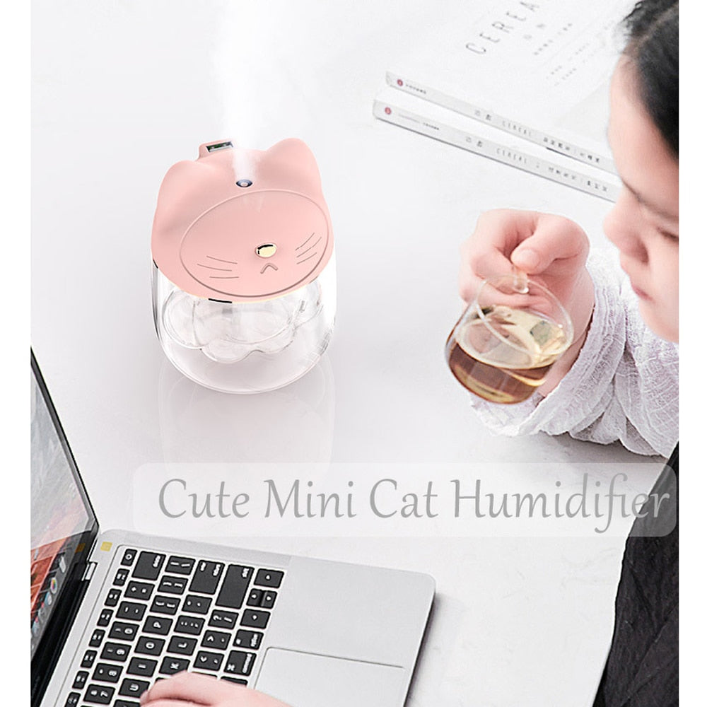 Girl Sipping Tea Next to Mini Cat Humidifier
