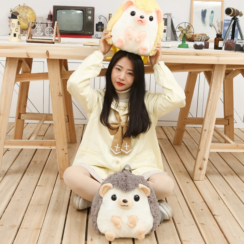 Model With Yellow and Grey Hedgehog Plushie Backpacks