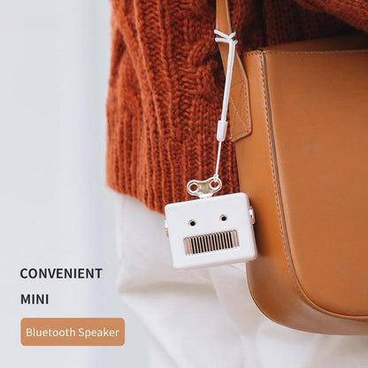 Kawaii White Robot Head Bluetooth Speaker attached to a purse
