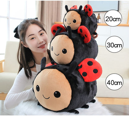 Model With Three Ladybug Plushies in Different Sizes