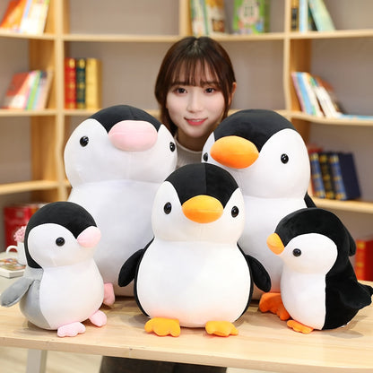 Model With Five Kawaii Penguin Plushies of Different Sizes