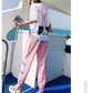Girl on a Boat Wearing Our Kawaii Peace Sakura Tracksuit