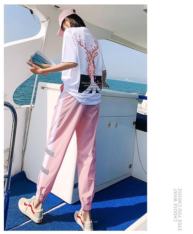 Girl on a Boat Wearing Our Kawaii Peace Sakura Tracksuit