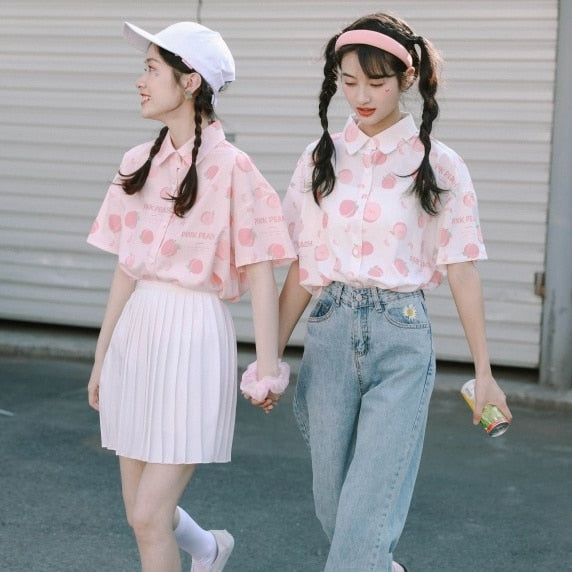 Models Wearing Pink and White Peach Print Blouses